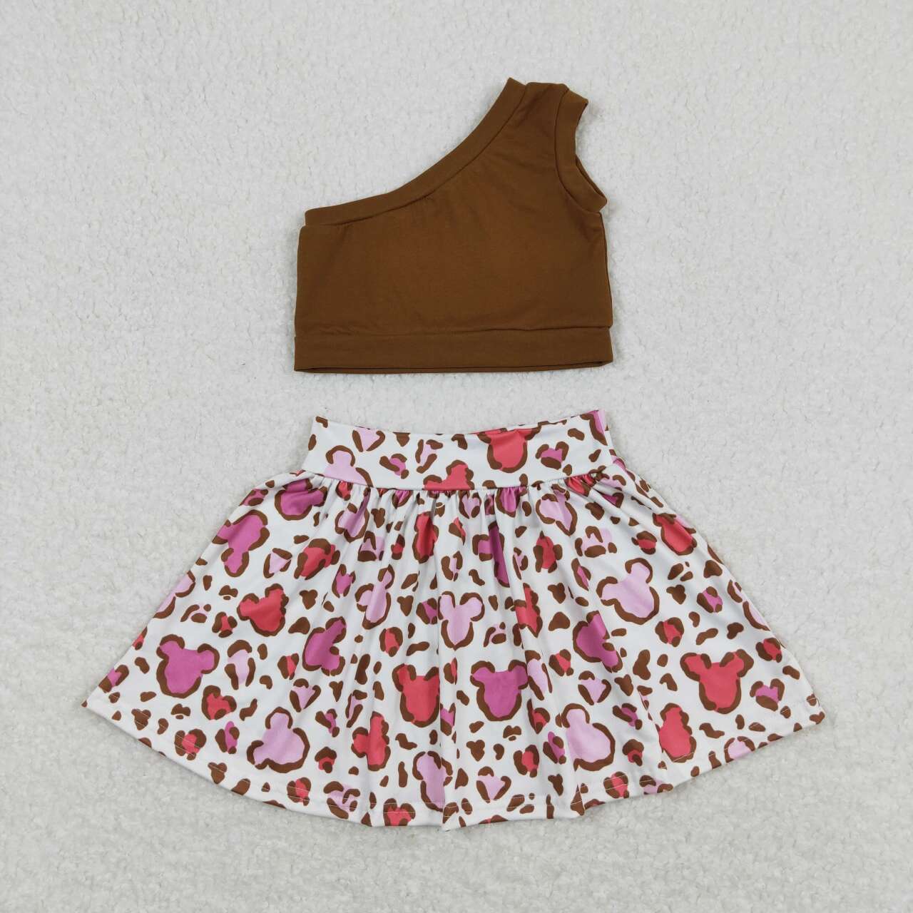 brown one shoulder top cartoon skirt outfit