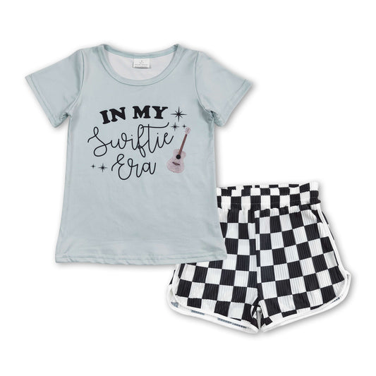 country music singer shirt checkered shorts summer outfit