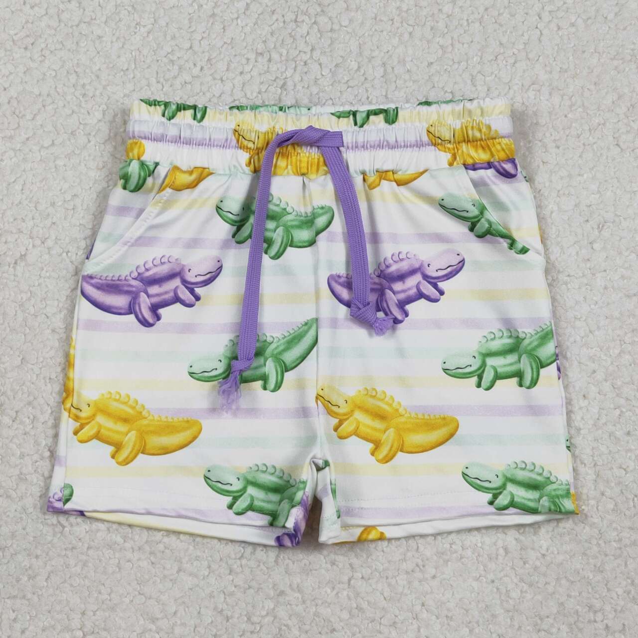 Baby boy Mardi Gras dinosaur swim trunks